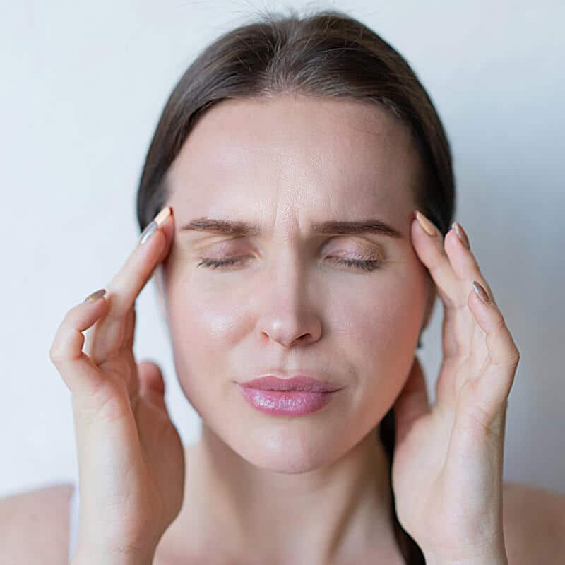 Woman experiencing migraine pain relief treatment